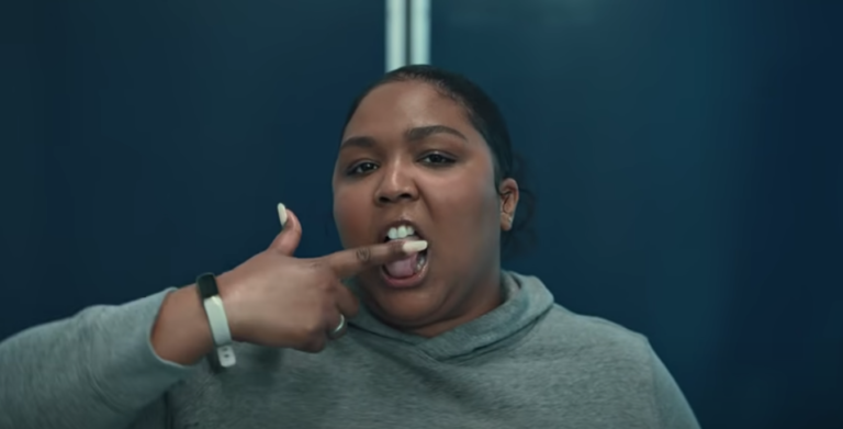 Lizzo licking finger in 