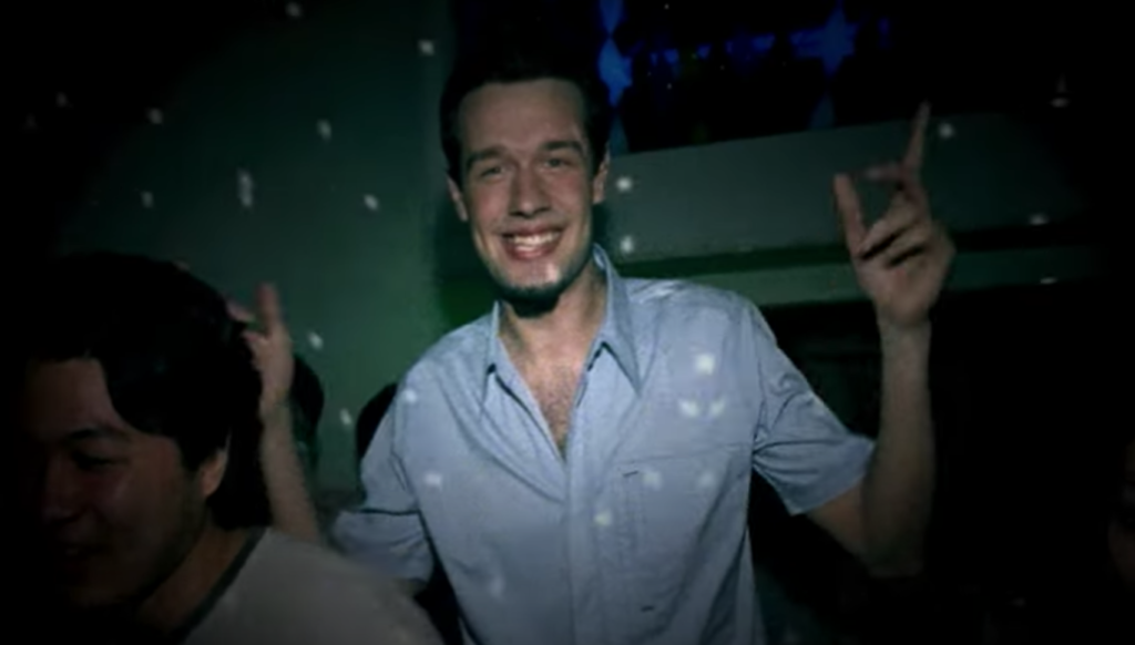 Italian DJ Spiller pictured dancing in a disco-ball lit house party for the music video for his single "Groovejet (If This Ain't Love)"